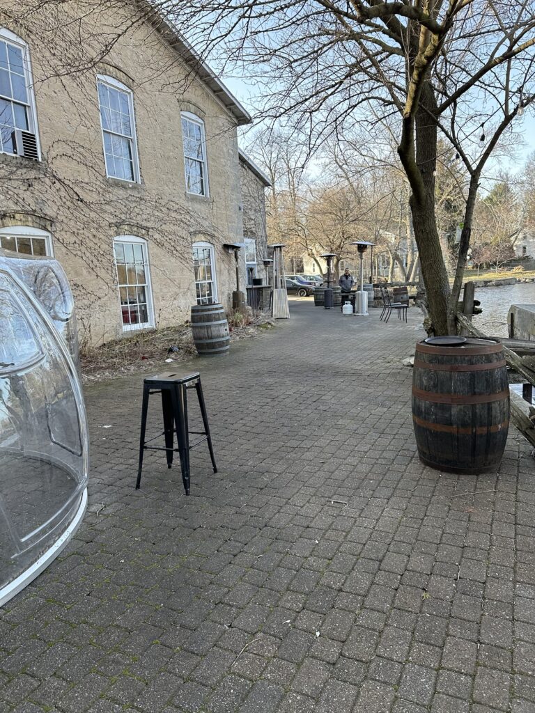 side patio area of the Anvil Pub and Grille situated along the Cedar Creek