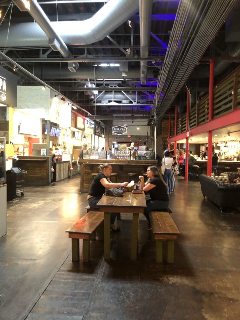 The inside of the Morgan Street Food Hall showing a dining table and the industrial looking ceiling.