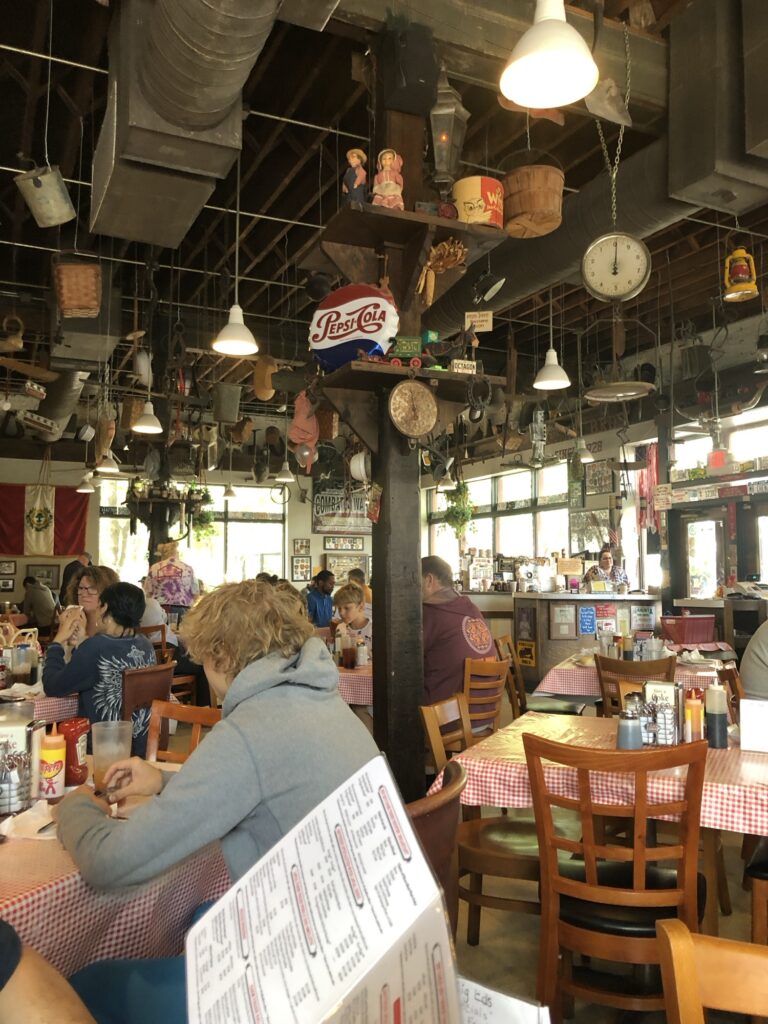 Inside Big Ed's Restaurant with funky antiques hanging from the ceiling.