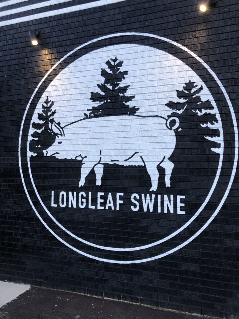 Longleaf Swine logo on the front of the building.