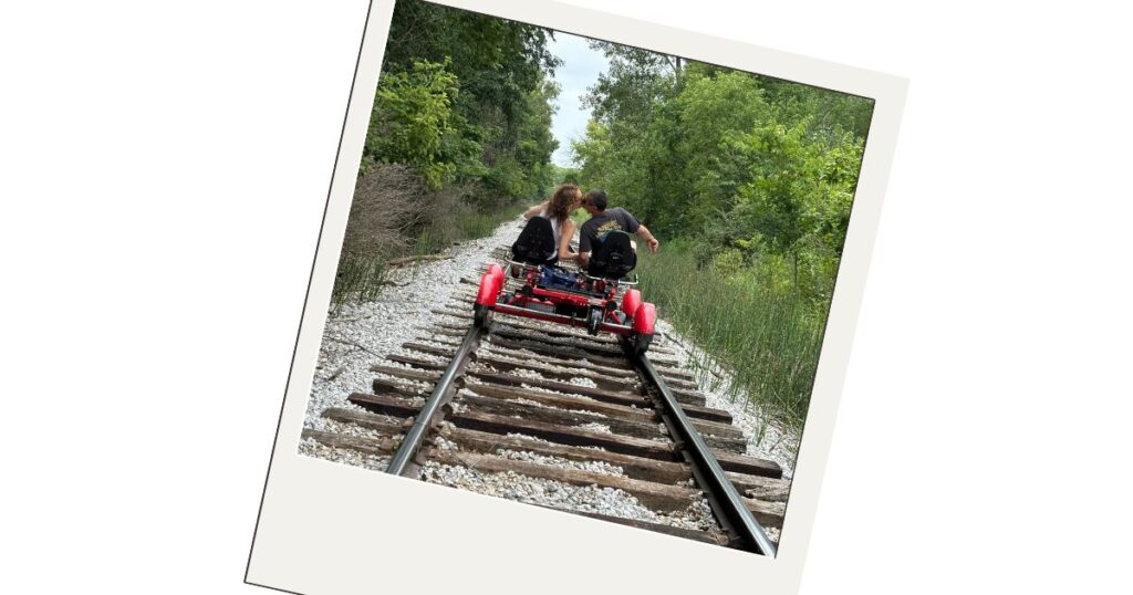 Dominic and I are kissing on the rail bike on the railroad tracks.