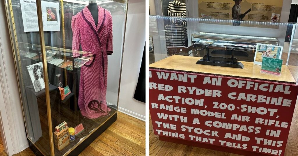 The image on the left shows a pink robe and other memorabilia from the movie inside a glass case.
The image on the right shows a Red Ryder BB gun inside a glass case. There is a red sign with white lettering on the front of the table. It says, "I want an official red ryder carbine action, 200-shot, range model air rifle with a compass in the stock and this thing that tells time!"