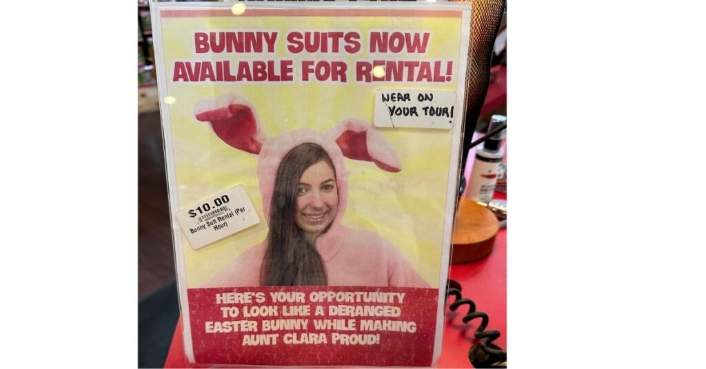 Sign that has a girl in a pink bunny suit that says, "Bunny suits now available for rental". "Wear on your tour!" "$10 per hour rental".