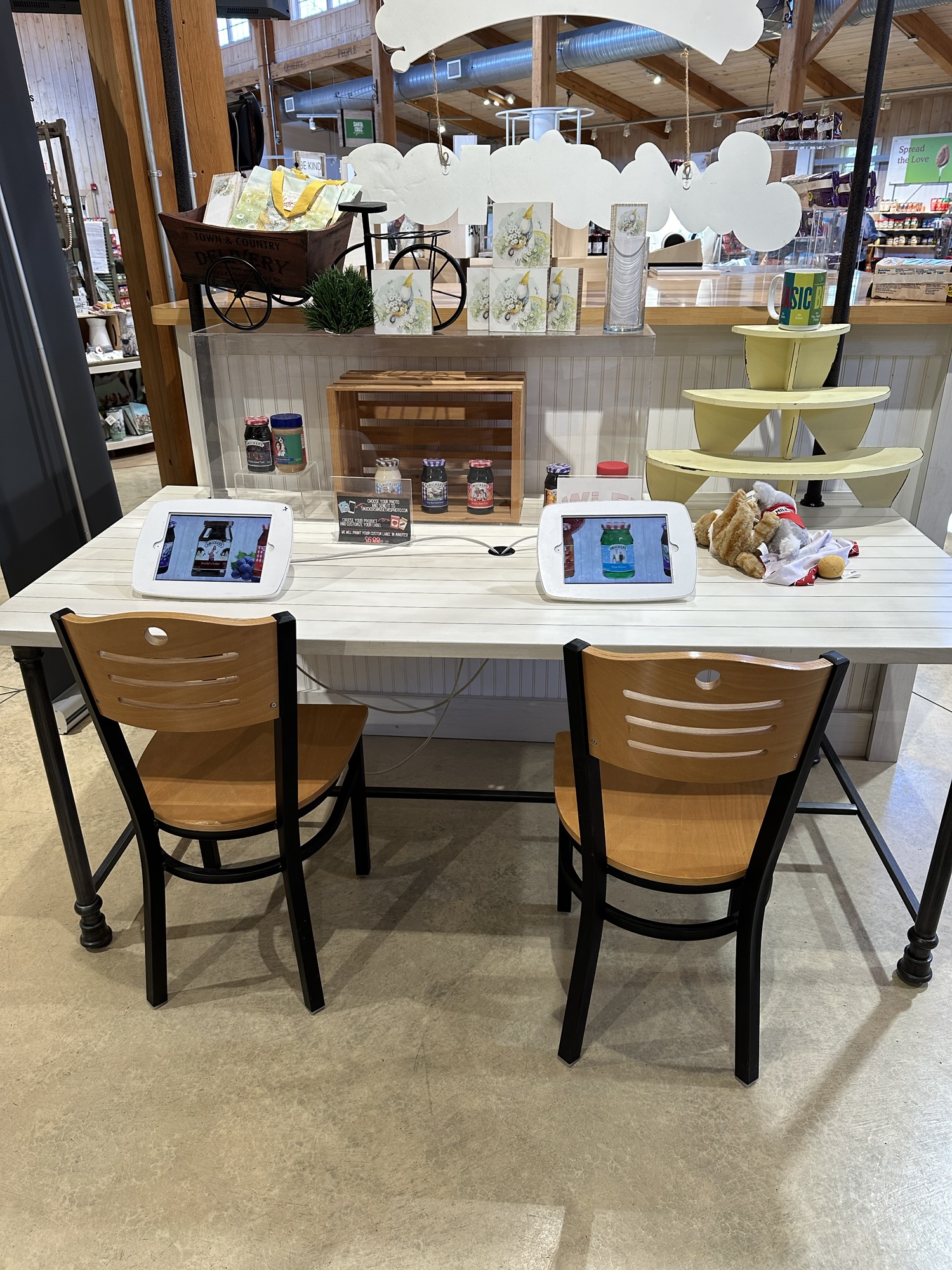 Table and chairs with 2 tablets that you can use to customize your Smucker's jar or Jif jar. 