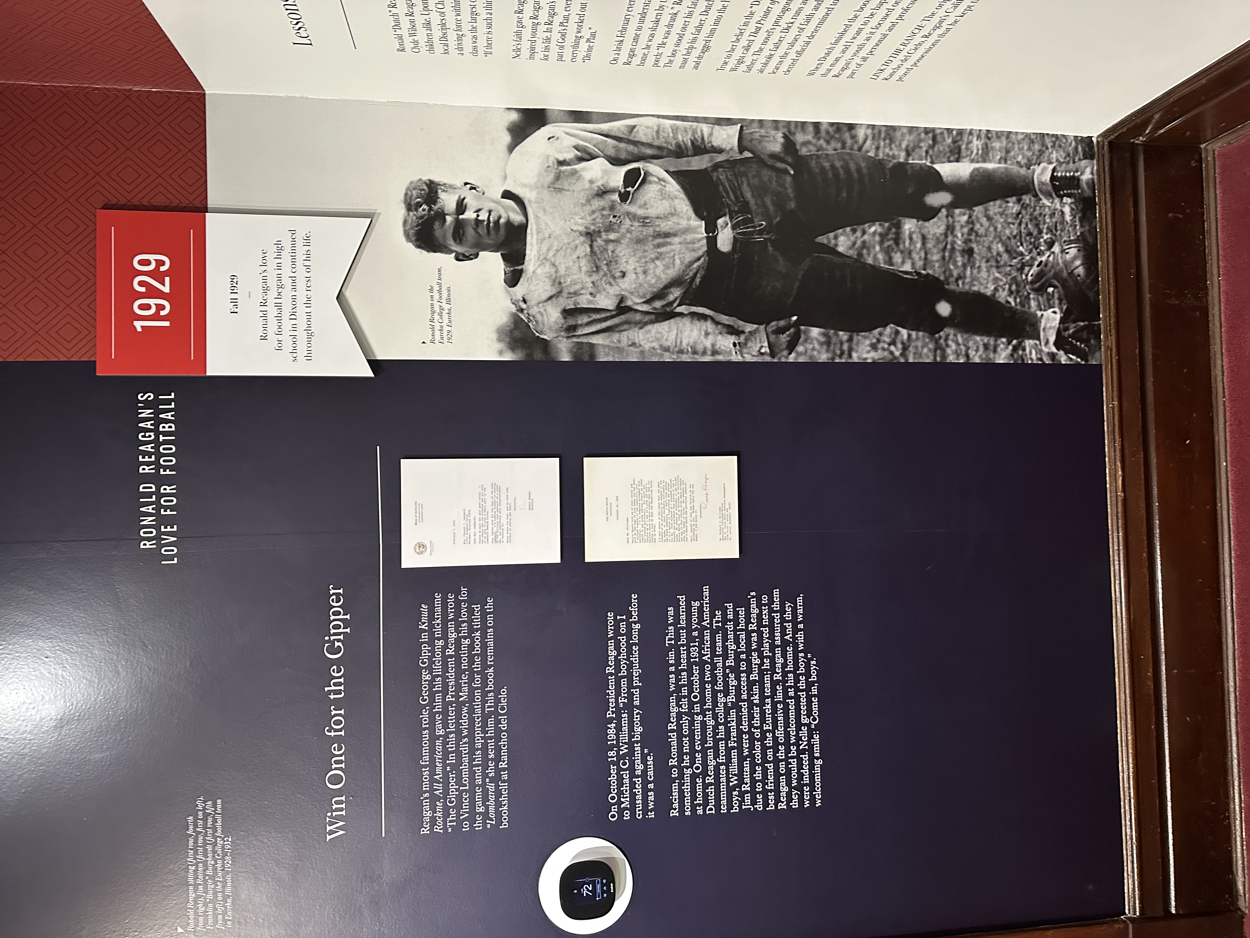 Museum display titled "Ronald Reagan's Love for Football" featuring a large black-and-white photo of Reagan in a vintage football uniform from 1929. The exhibit includes text about Reagan’s role as George Gipp in Knute Rockne, All American, letters referencing Vince Lombardi, and a story about his stand against racism in high school. A red banner highlights that Reagan’s passion for football began in Dixon in fall 1929.